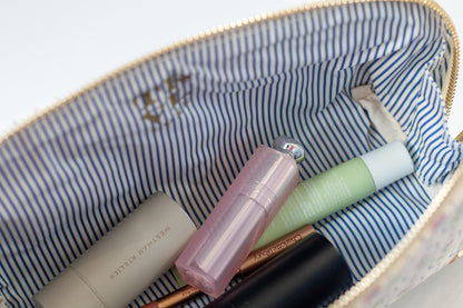 Makeup items in a striped makeup bag