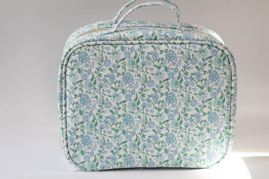 Floral patterned toiletry bag on a light gray background