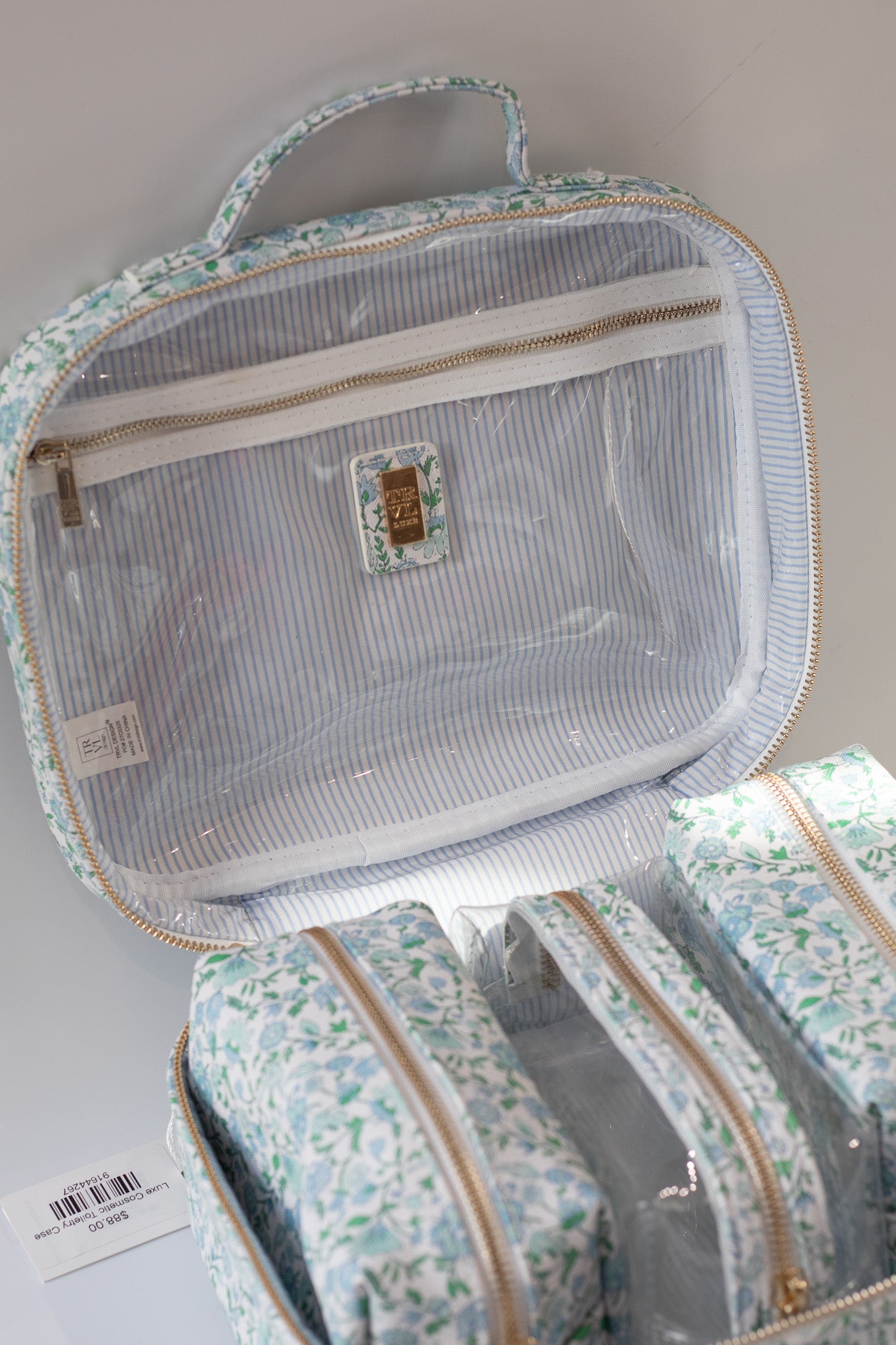 Clear travel pouch with floral pattern on a light gray background