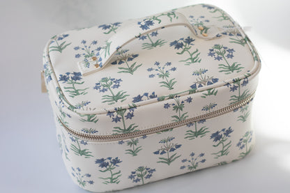 Floral-patterned makeup bag on  a light gray background