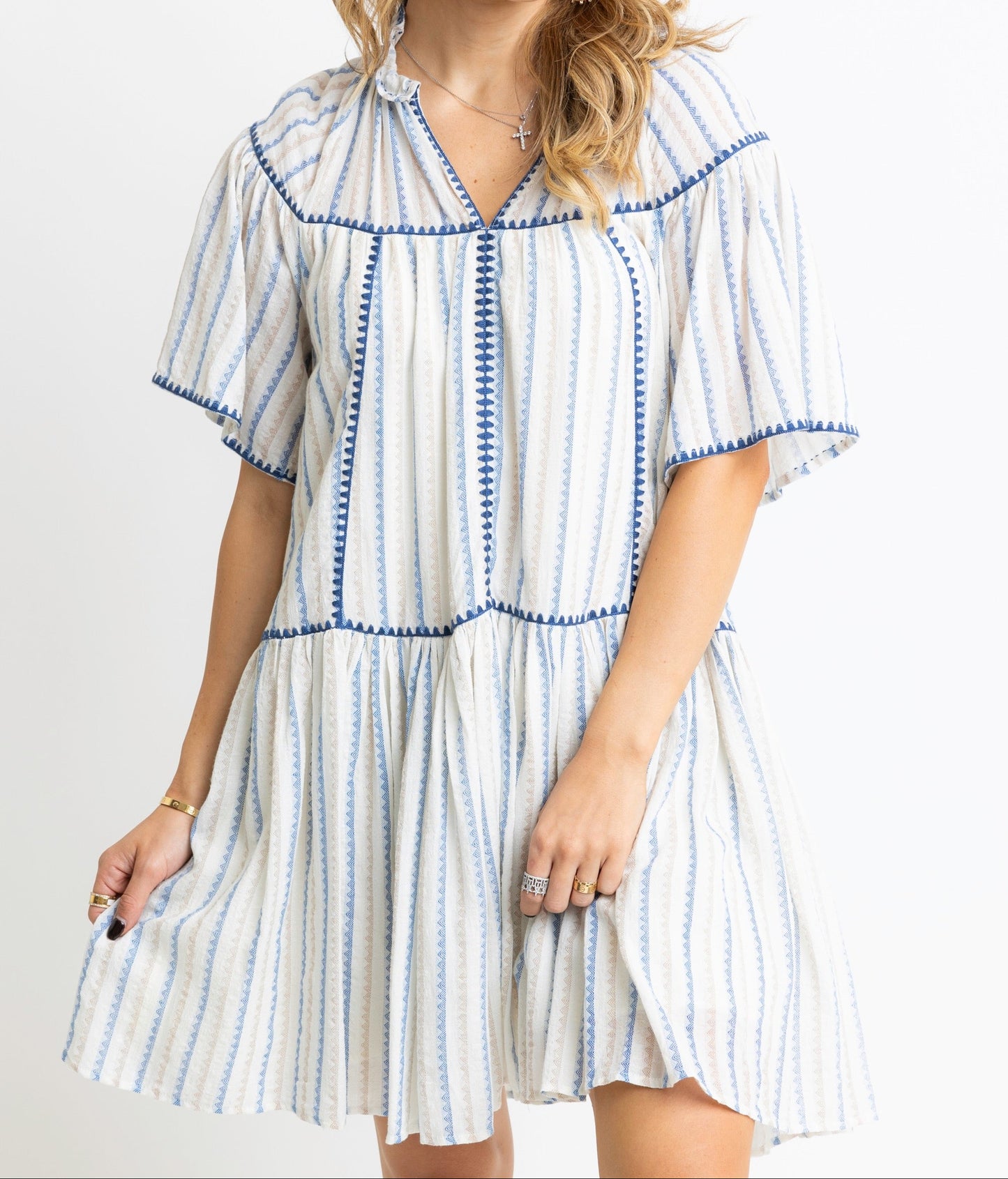 Woman wearing a striped dress with a plain background