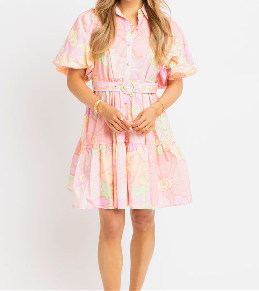 Woman wearing a pink floral dress on a white background