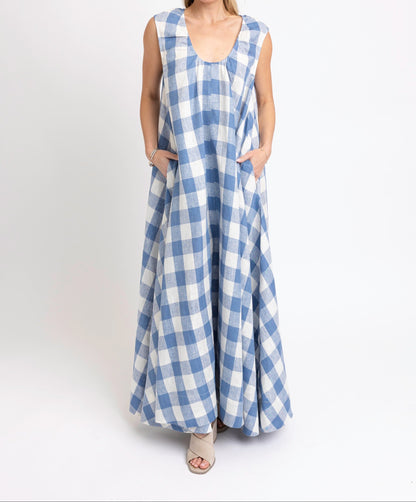 Woman wearing a blue and white checkered dress on a white background