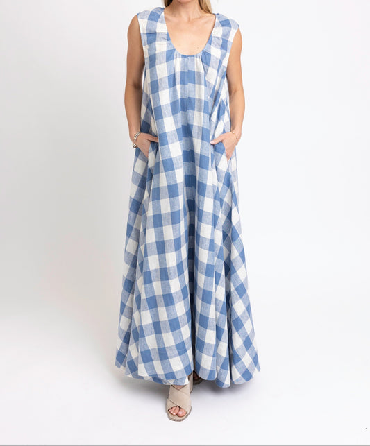 Woman wearing a blue and white checkered dress on a white background
