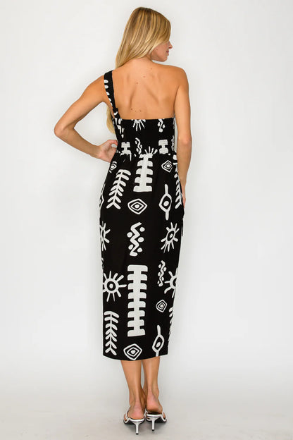 Woman wearing a black dress with white patterns on a white background