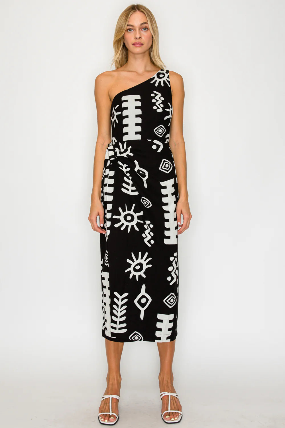 Woman wearing a black dress with white patterns on a white background