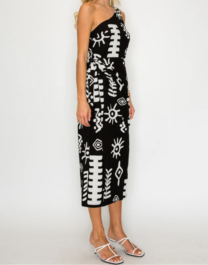 Woman wearing a black dress with white patterns on a white background