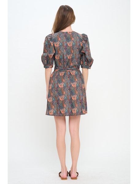 Woman wearing a patterned dress on a white background