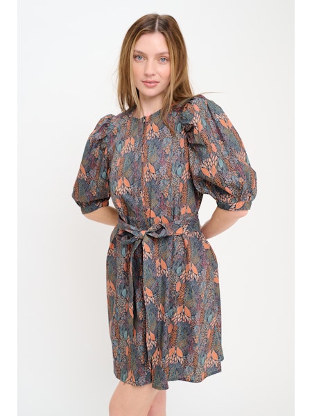 Woman wearing a patterned dress on a white background
