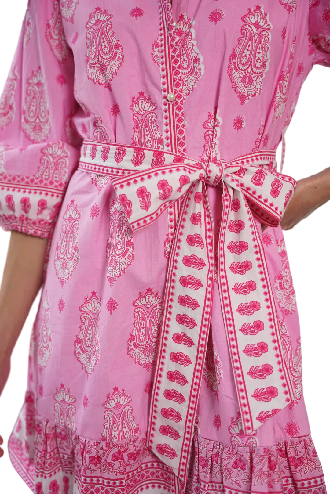 Pink dress with white paisley pattern worn by a person