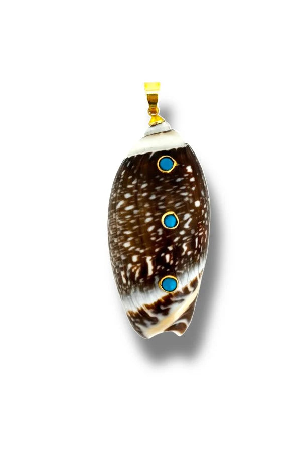 Shell pendant with blue stones and gold accents on a white background