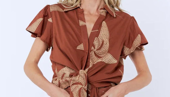 Woman wearing a brown floral dress on a white background