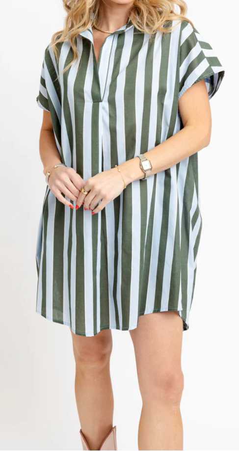 A woman modeling a short-sleeve collared shift dress with vertical green and white stripes, standing against a plain white studio background.
