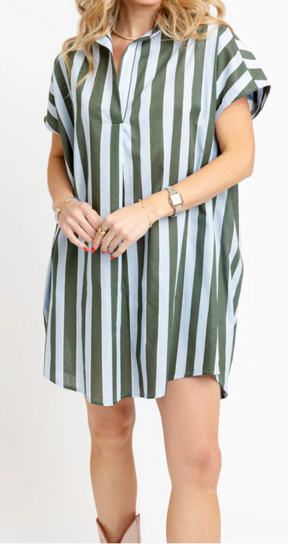 A woman modeling a short-sleeve collared shift dress with vertical green and white stripes, standing against a plain white studio background.