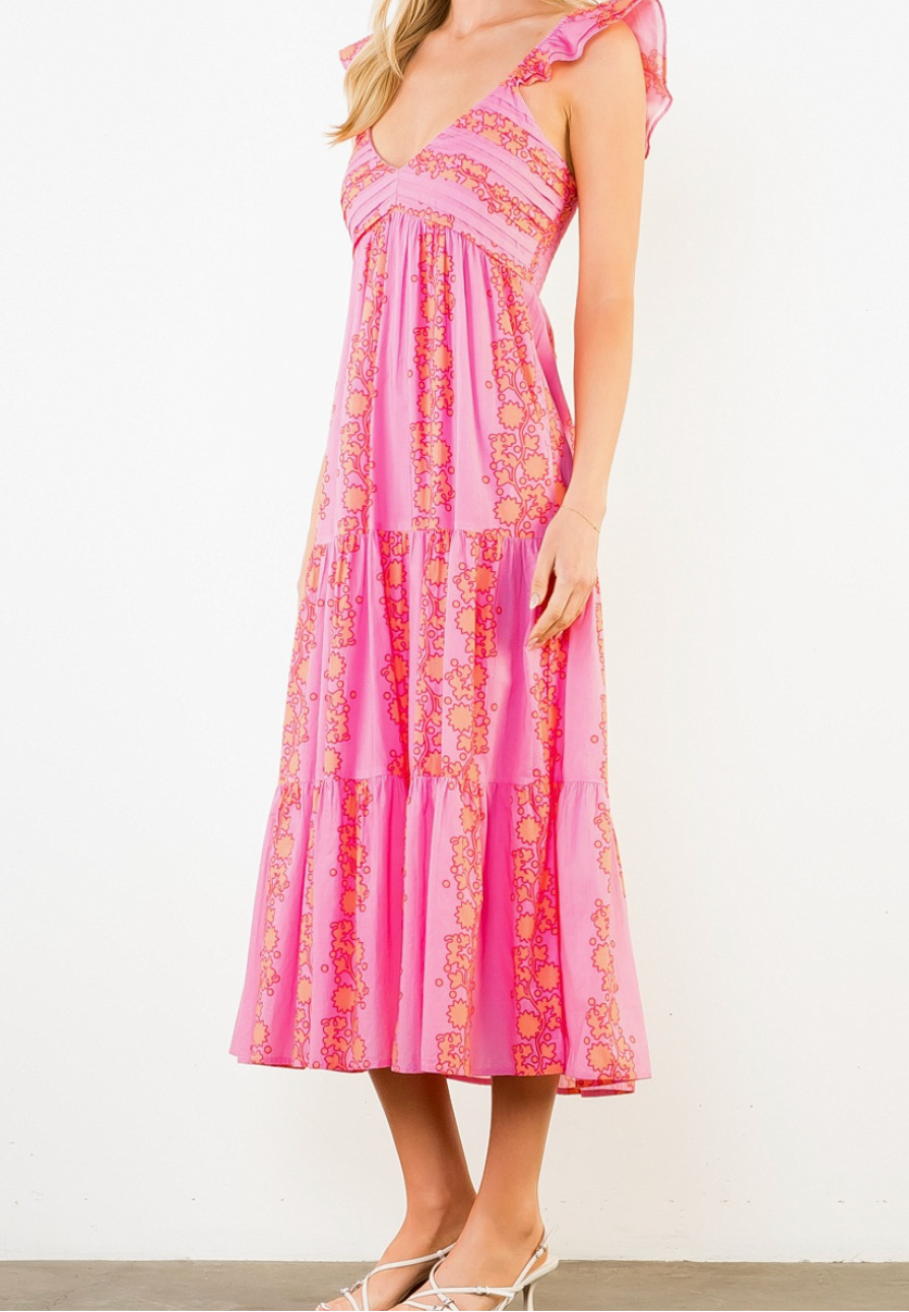 Woman wearing a pink patterned dress on a white background