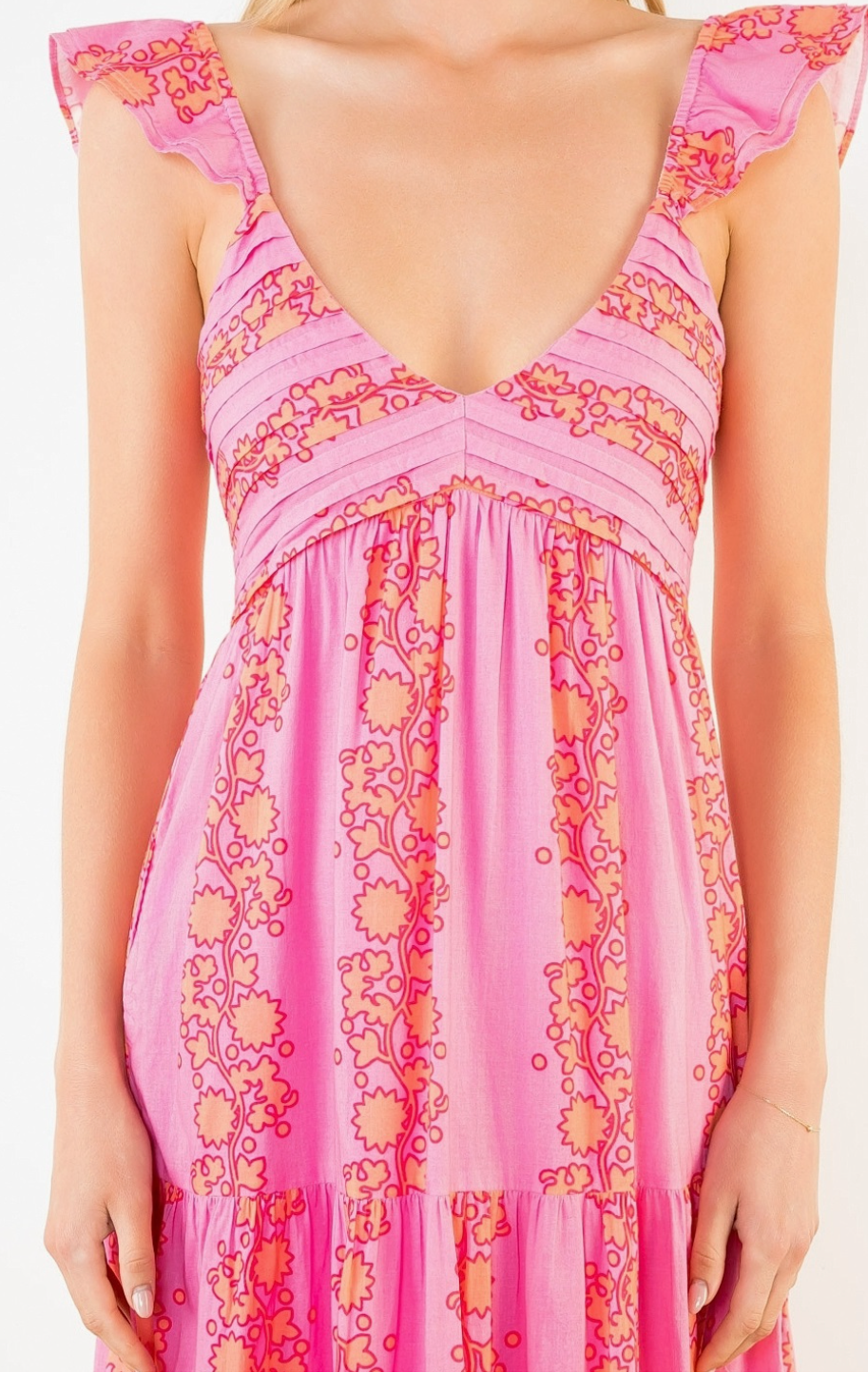 Pink floral dress with a deep neckline on a white background