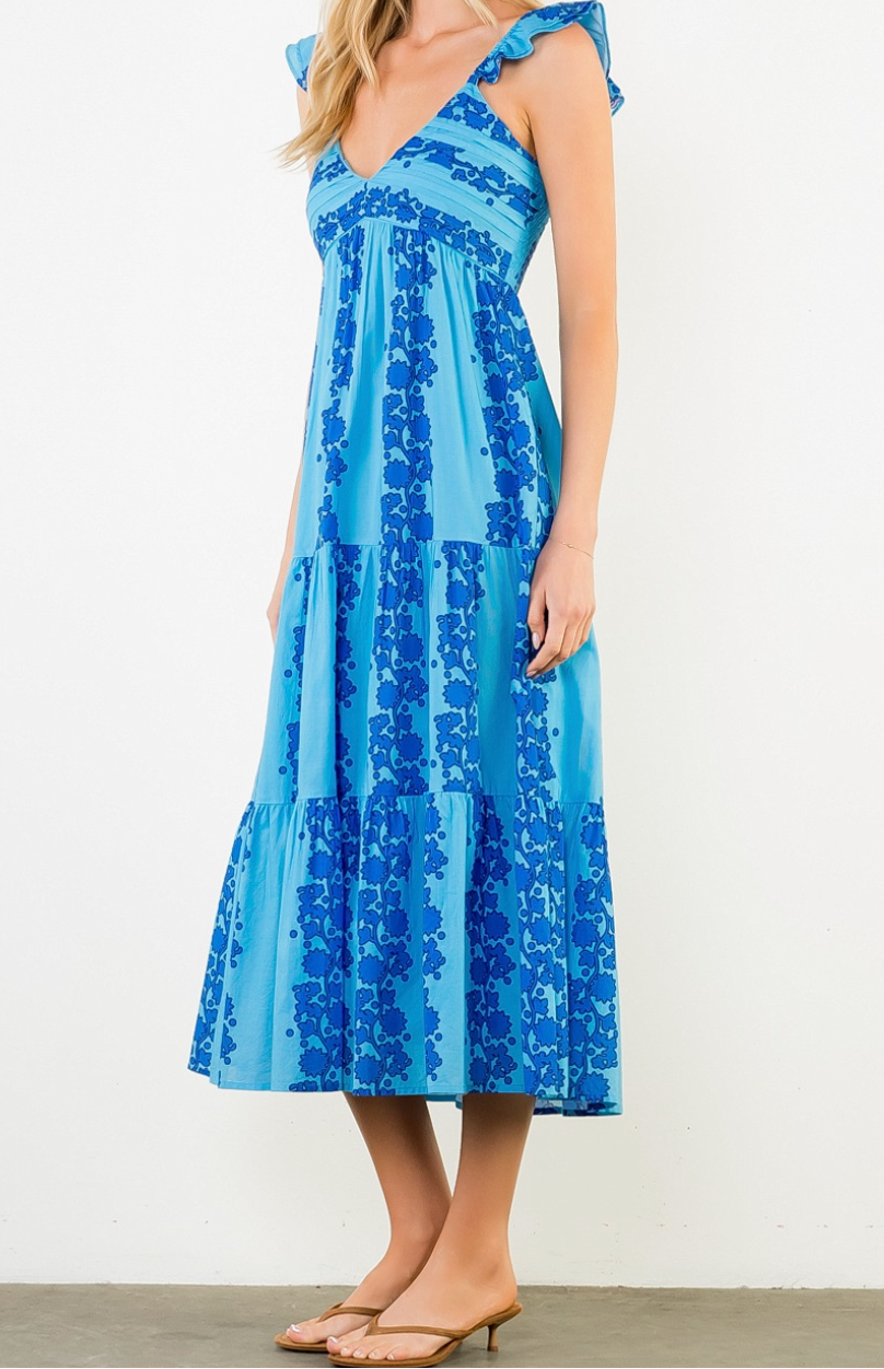 Woman wearing a blue floral dress on a white background