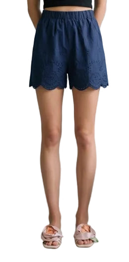 Woman wearing navy eyelet shorts