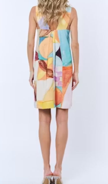 Woman wearing a colorful geometric-patterned dress on a white background