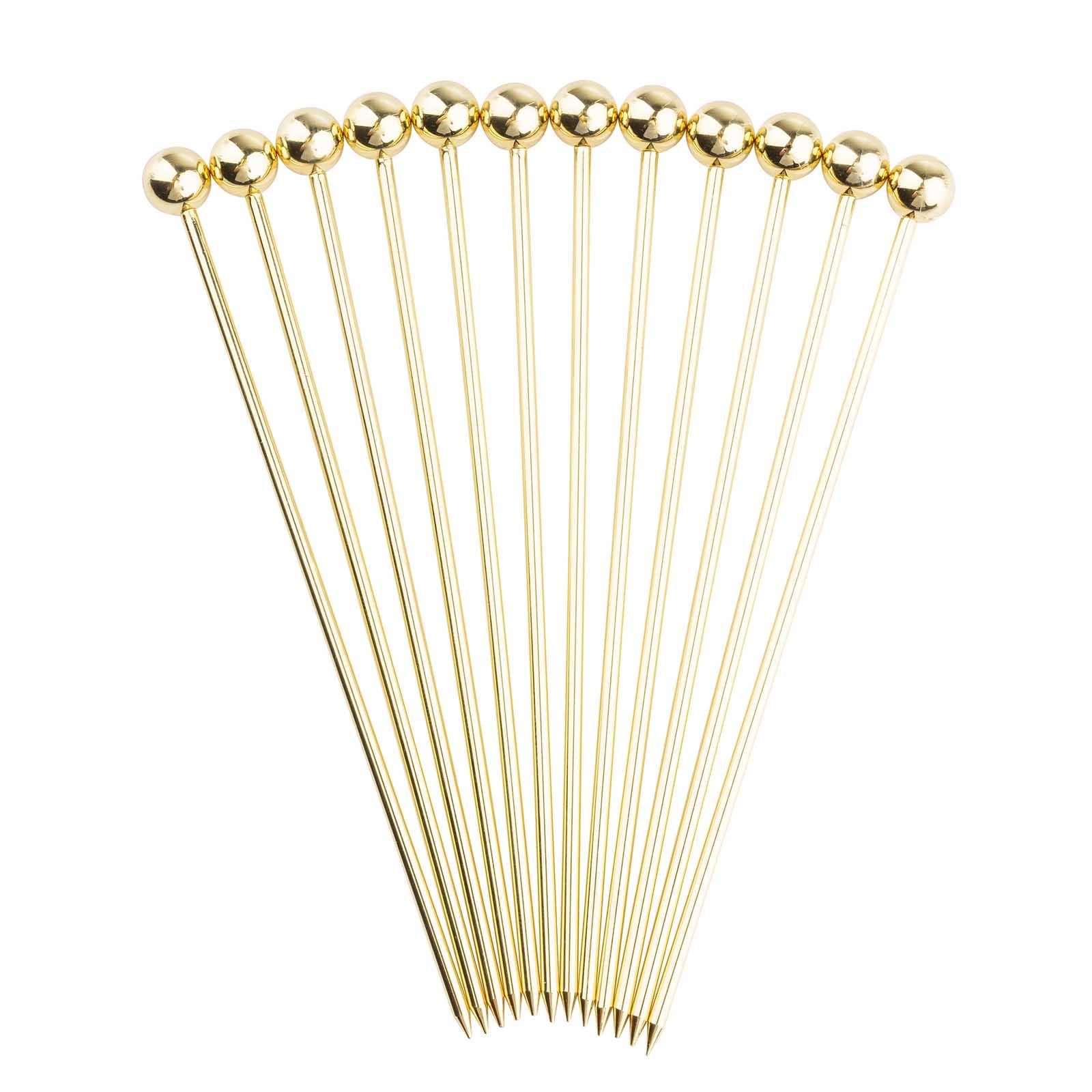 Set of gold hairpins on a white background