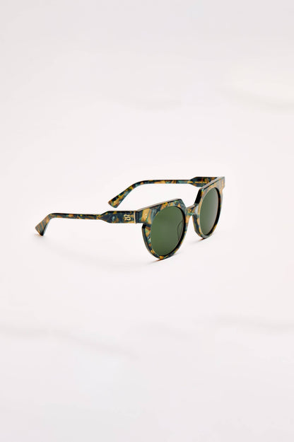Round sunglasses with a green and brown tortoiseshell patterned frame and dark green lenses, shown on a plain white background.
