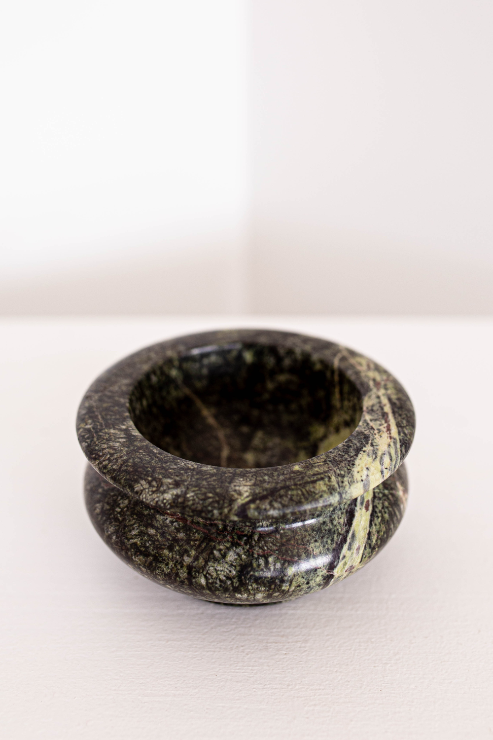 Black stone bowl with natural patterns on a white background