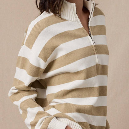 Woman wearing a beige and white striped sweater with a beige headband against a beige background