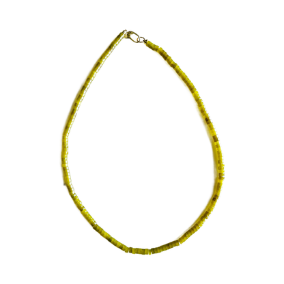 Yellow beaded necklace on a white background
