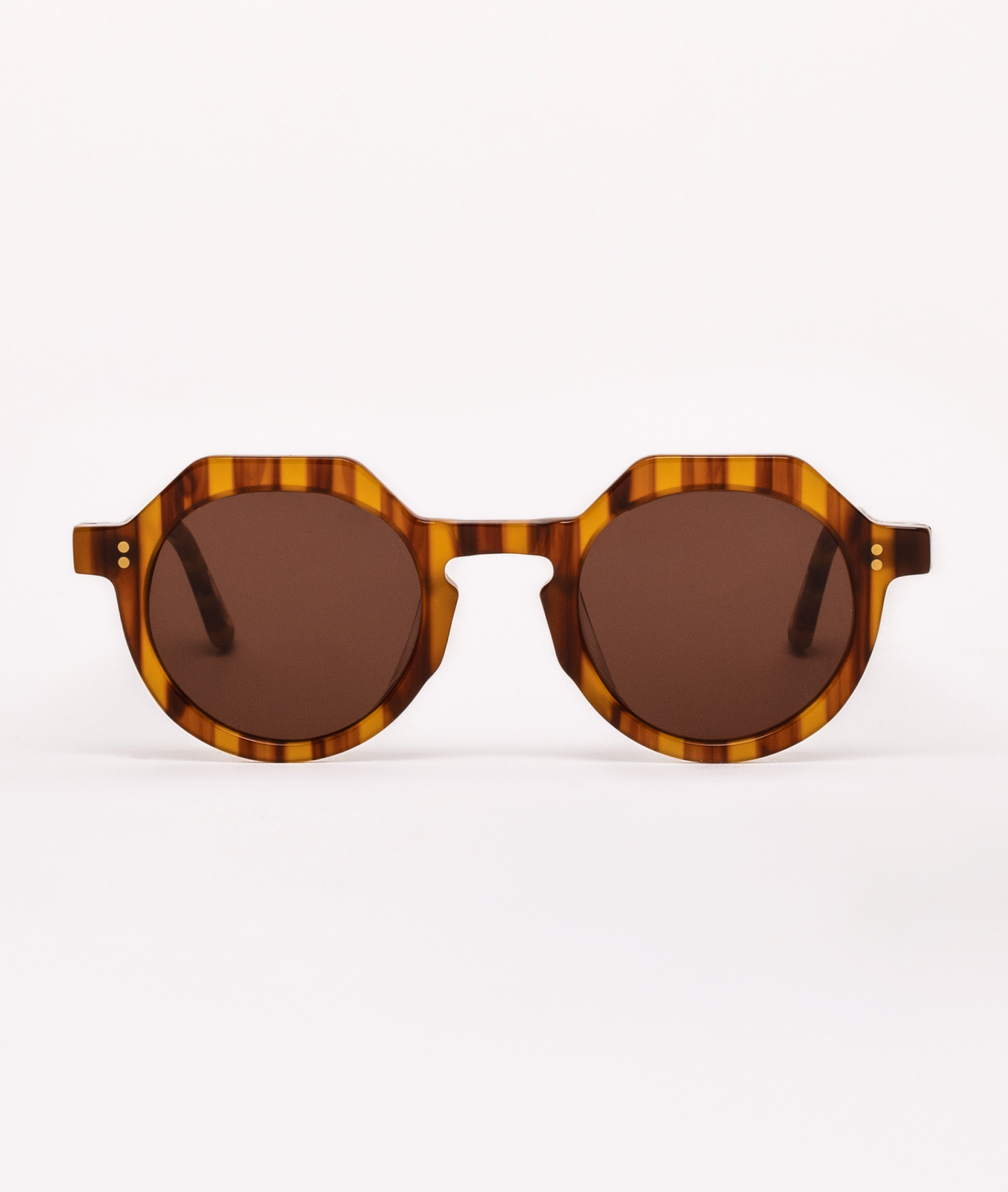 Sunglasses with tortoiseshell frame and brown lenses on a white background