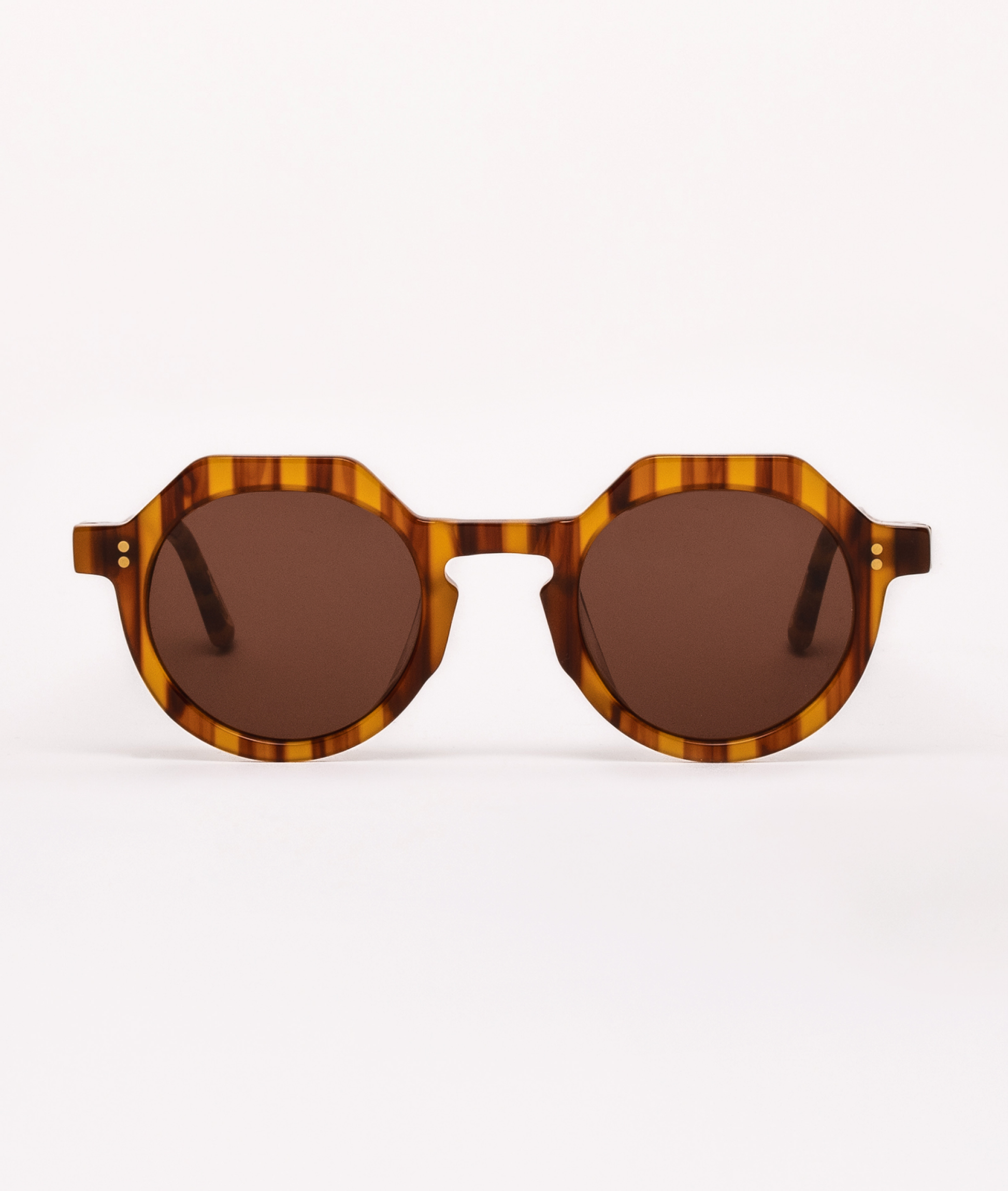 Sunglasses with tortoiseshell frame and brown lenses on a white background