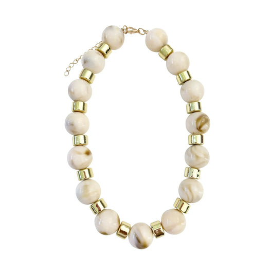 Necklace with cream beads and gold accents on a white background