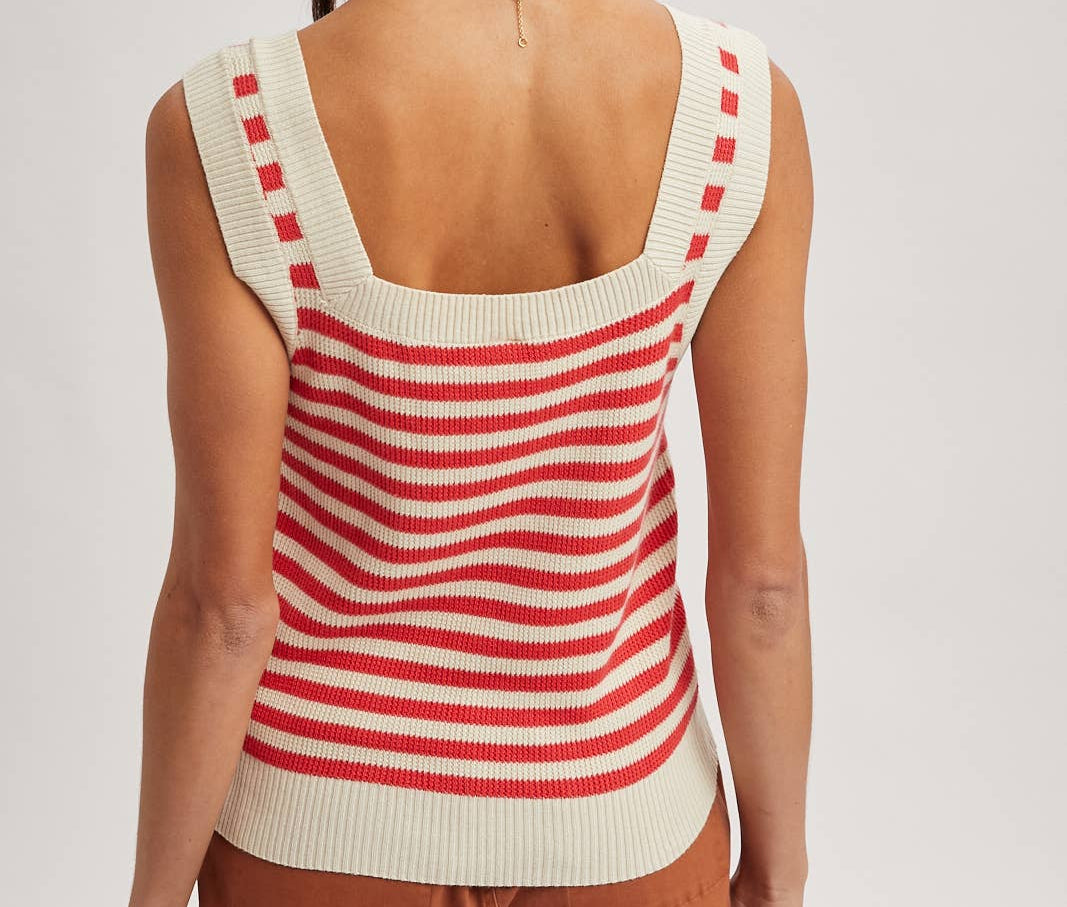 Woman wearing a red and white striped sleeveless top on a plain background