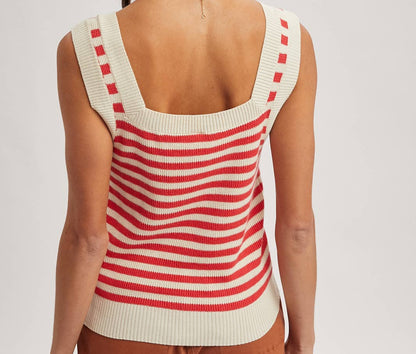 Woman wearing a red and white striped sleeveless top on a plain background