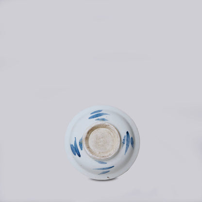 Ceramic bowl with blue designs on a light gray background