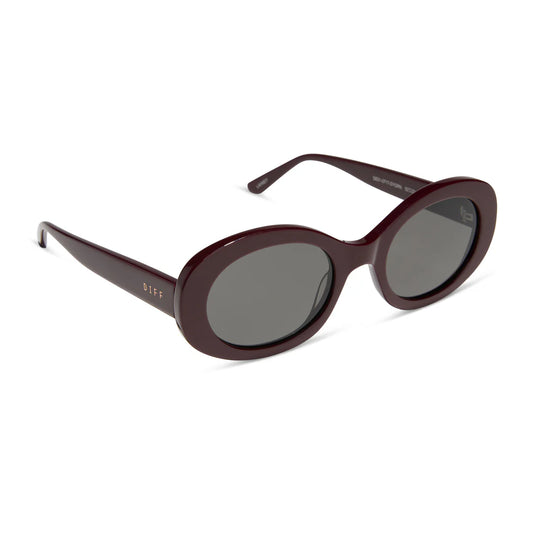 Sunglasses with a dark cherry frame and dark lenses on a white background