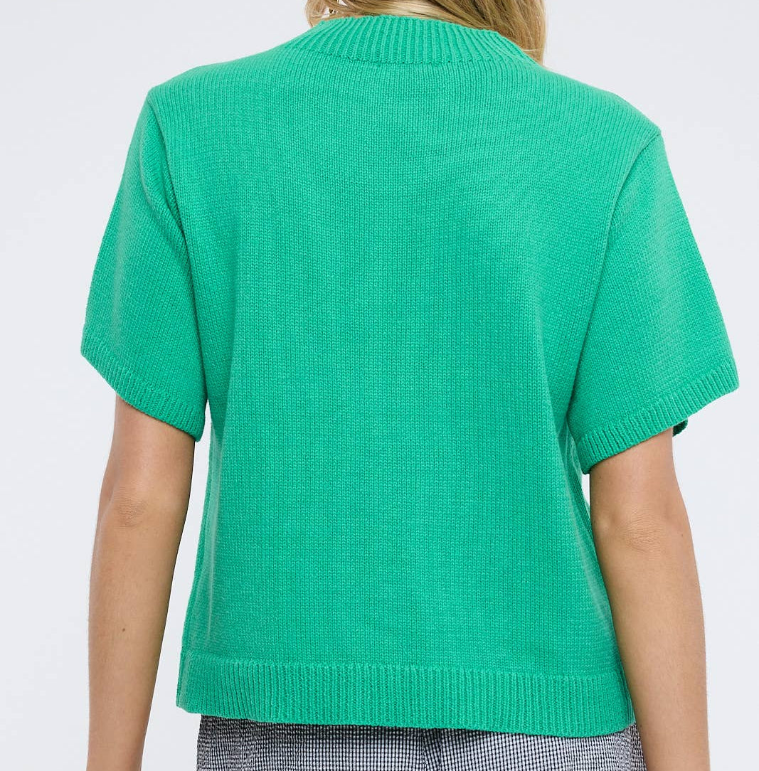 Person wearing a green sweater on a white background