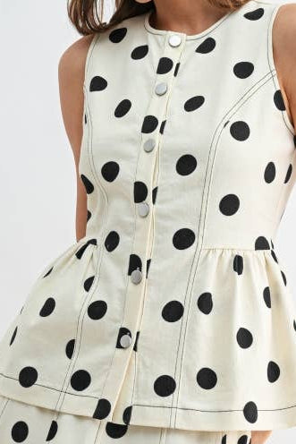 Woman wearing a polka dot shirt on a white background