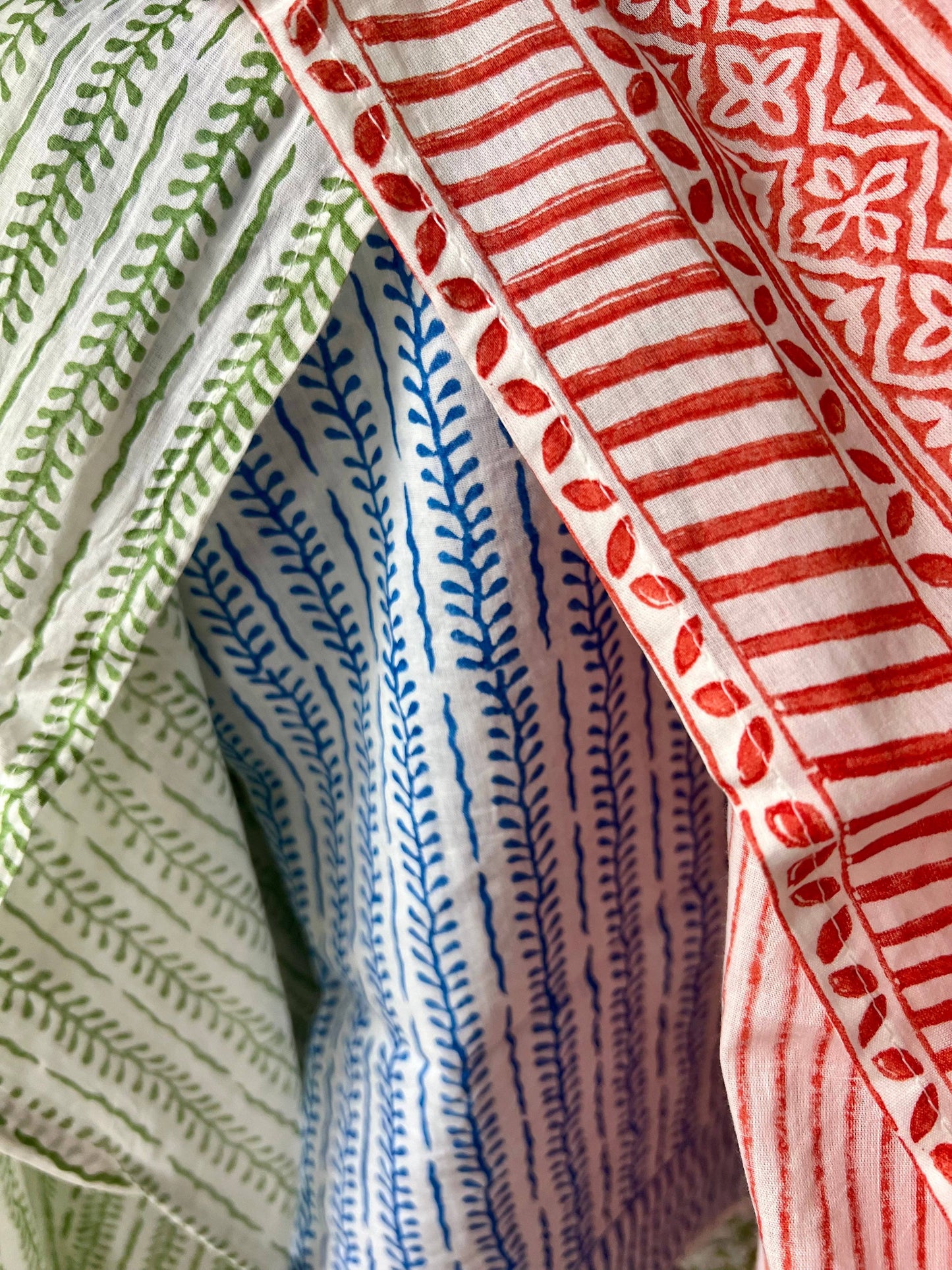 Close-up of fabric with green, blue, and red patterns.