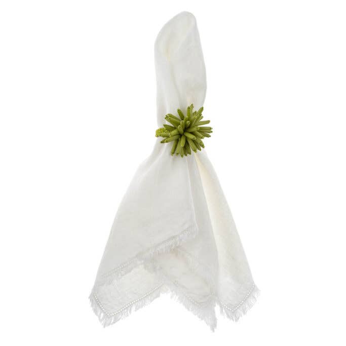 White napkin with a green decorative element on a white background