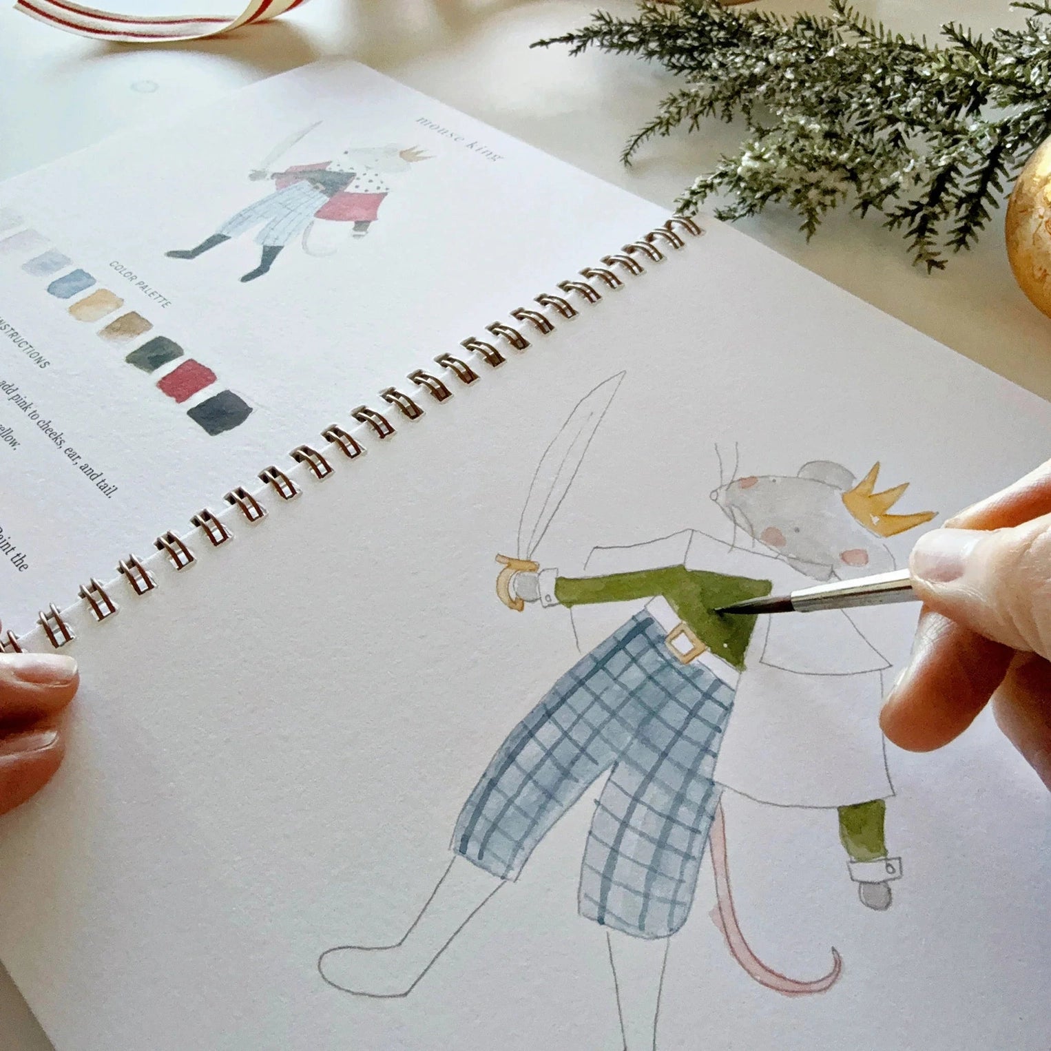 Person coloring a drawing of a character in a notebook with a pen.