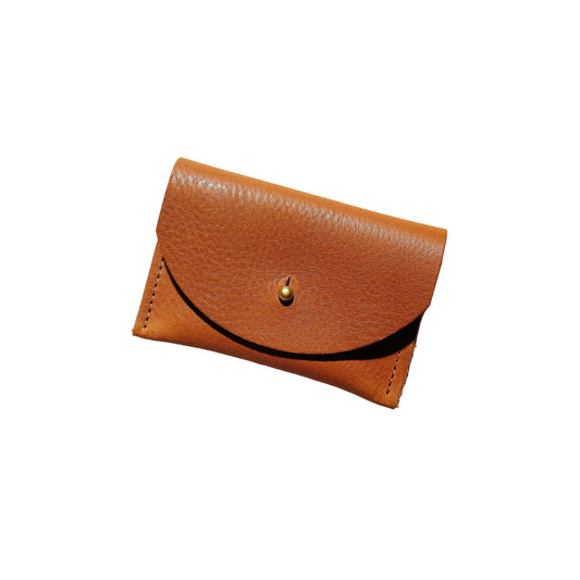 Brown leather wallet on a beige background
