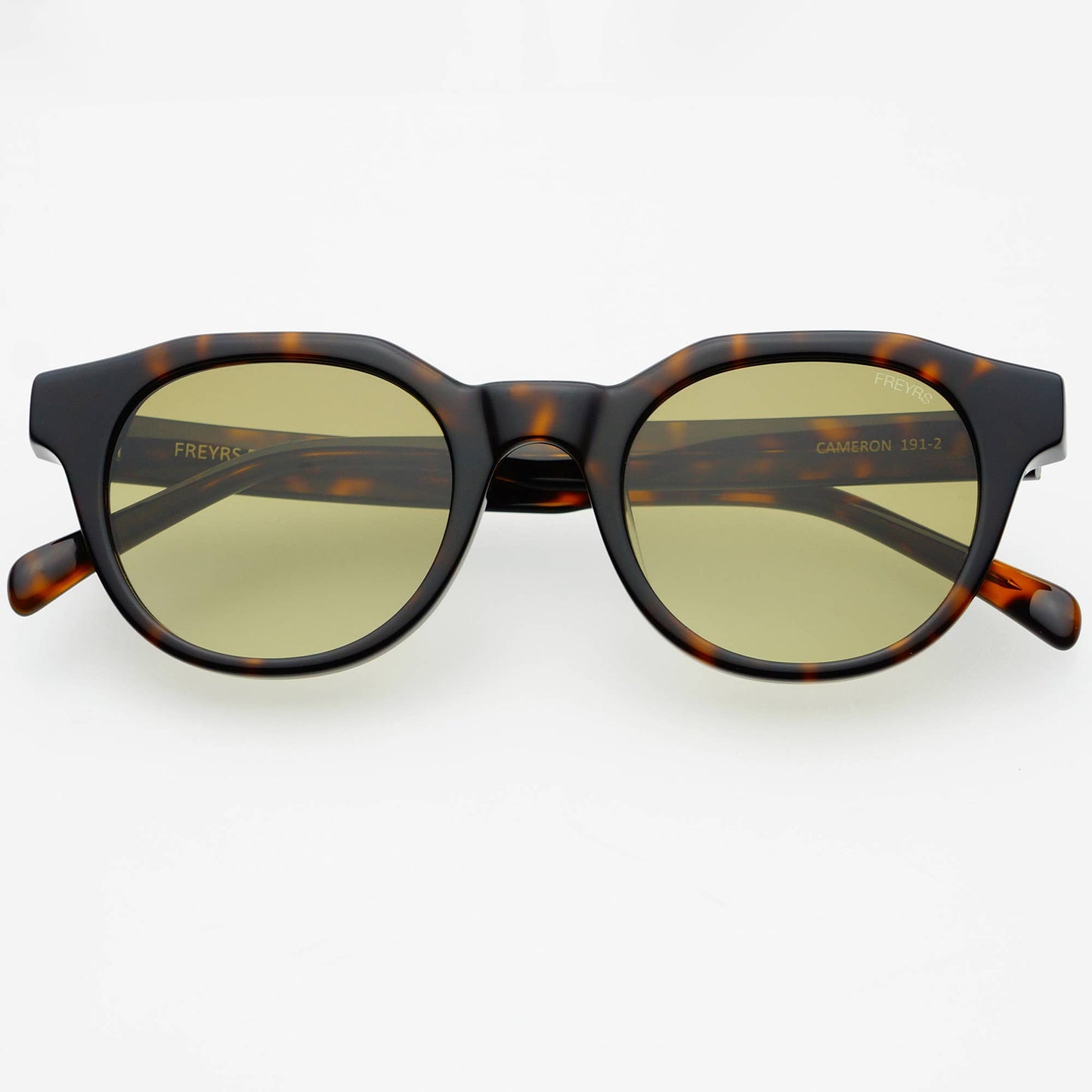 Sunglasses with tortoiseshell frame and gold lenses on a white background