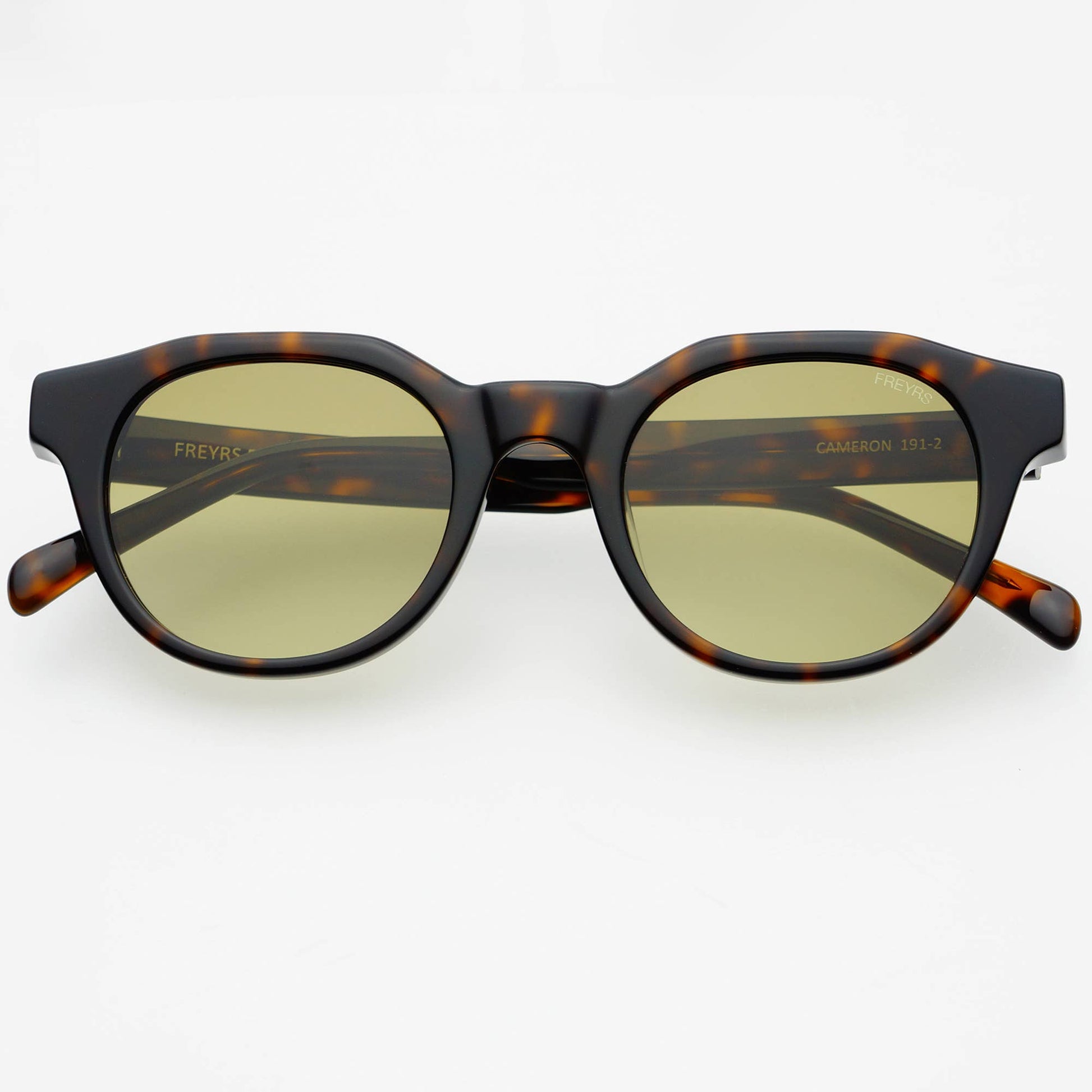 Sunglasses with tortoiseshell frame and gold lenses on a white background