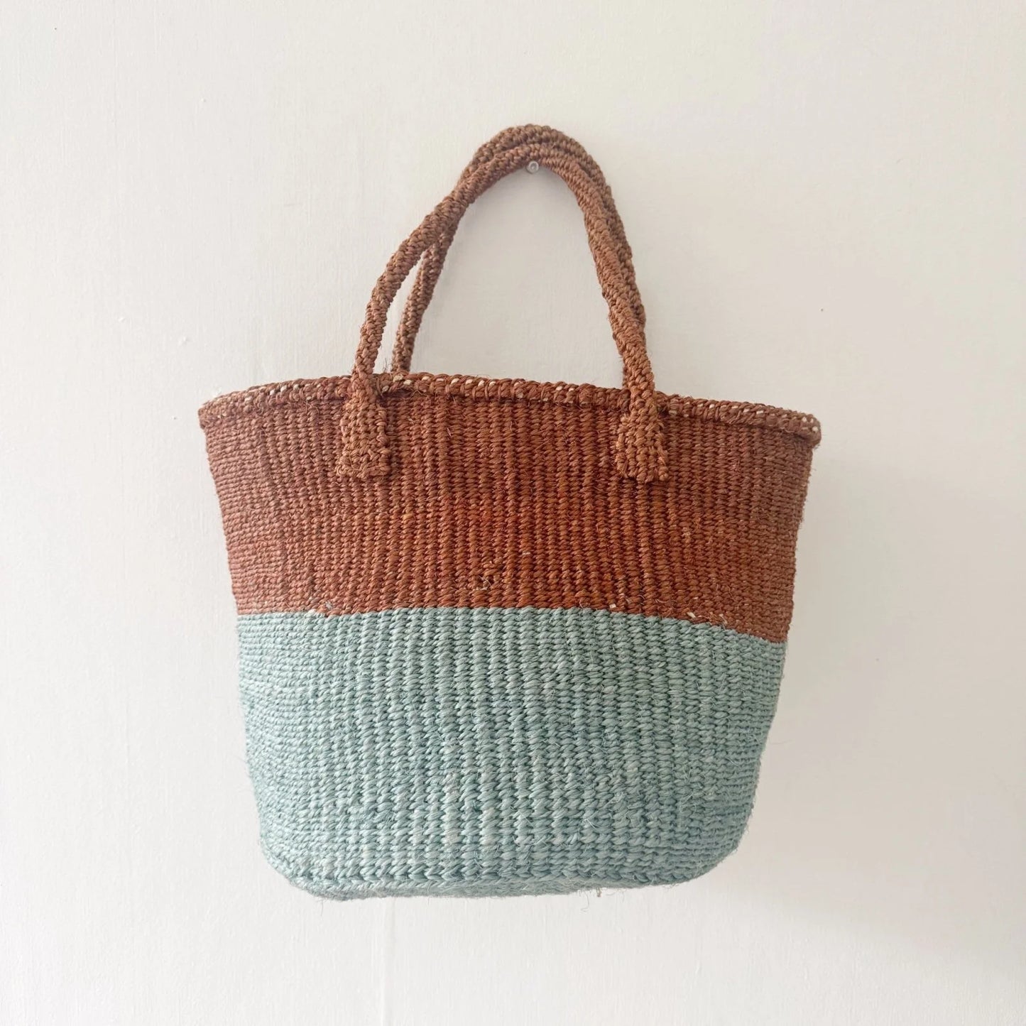 Woven bag with two-tone design on a white background