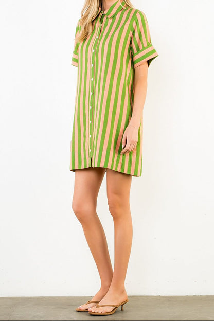 Woman wearing a green and pink striped dress on a white background