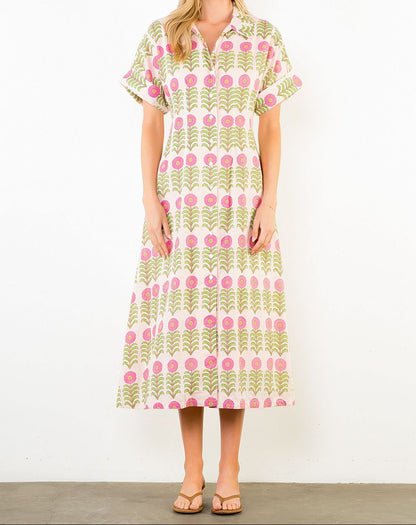 Woman wearing a patterned dress against a white background