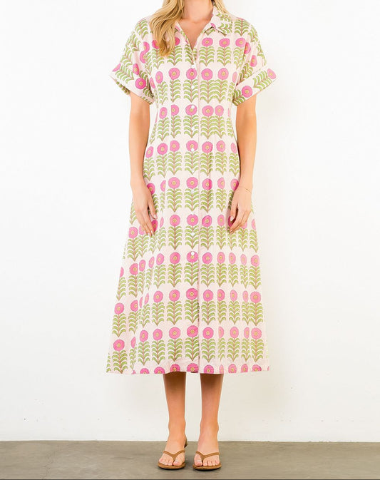 Woman wearing a patterned dress against a white background