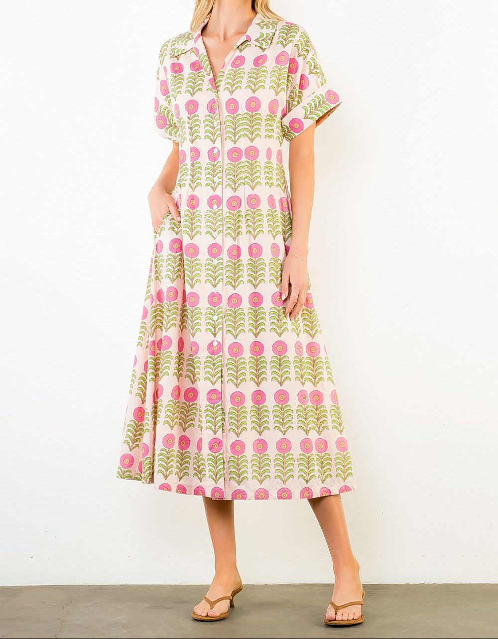 Woman wearing a patterned dress against a white background