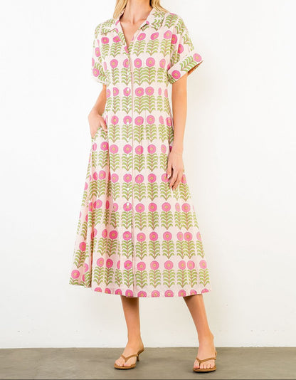 Woman wearing a patterned dress against a white background
